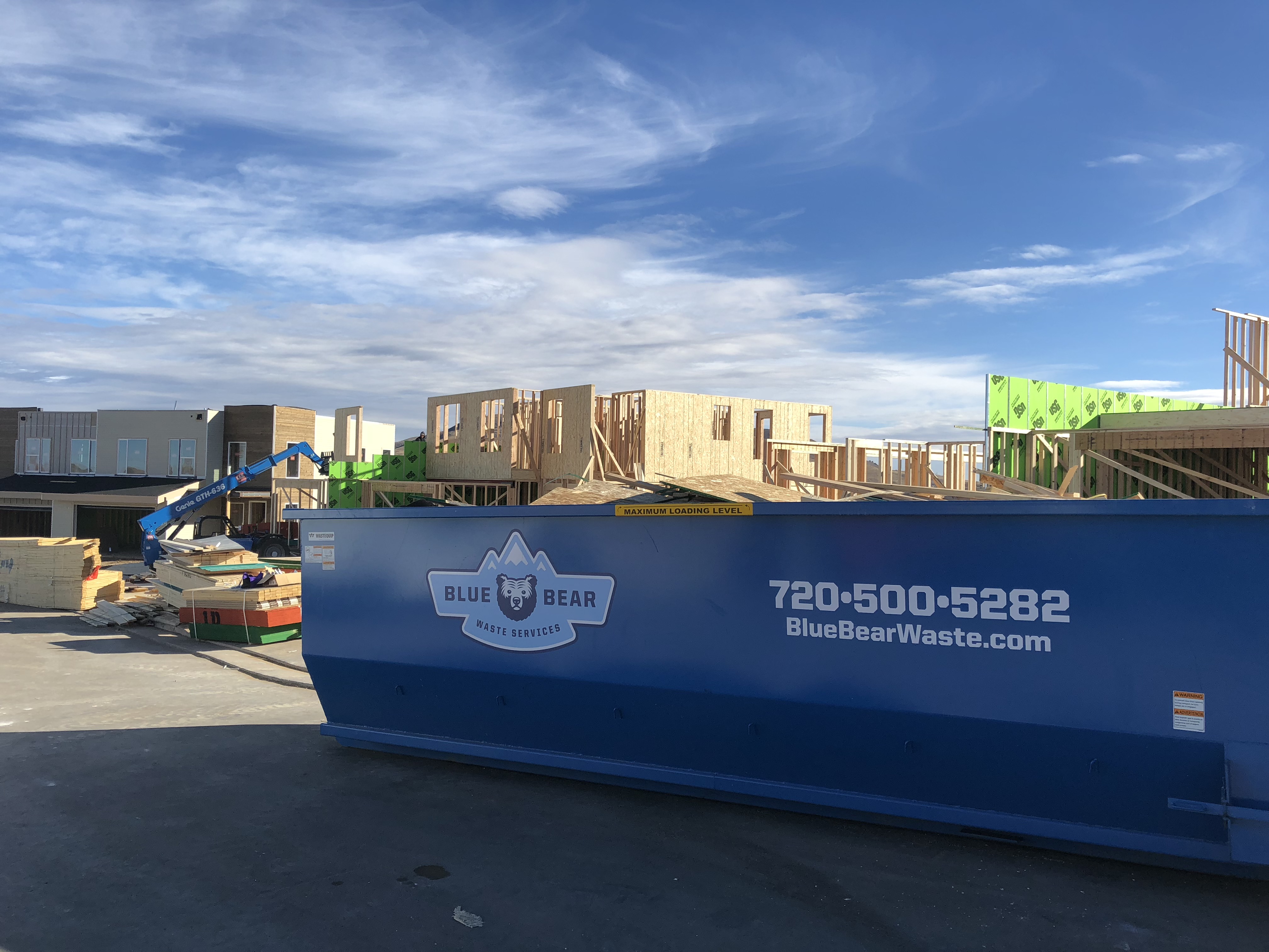 A dumpster sitting in the middle of a construction site.