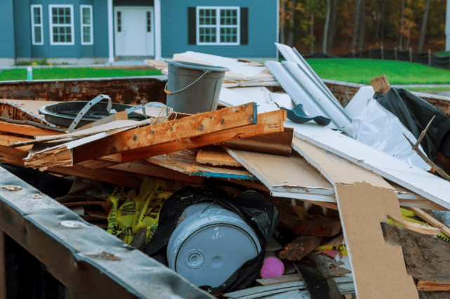 A pile of debris in front of a house.