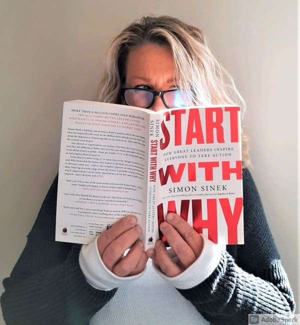 A woman holding an open book with the words 