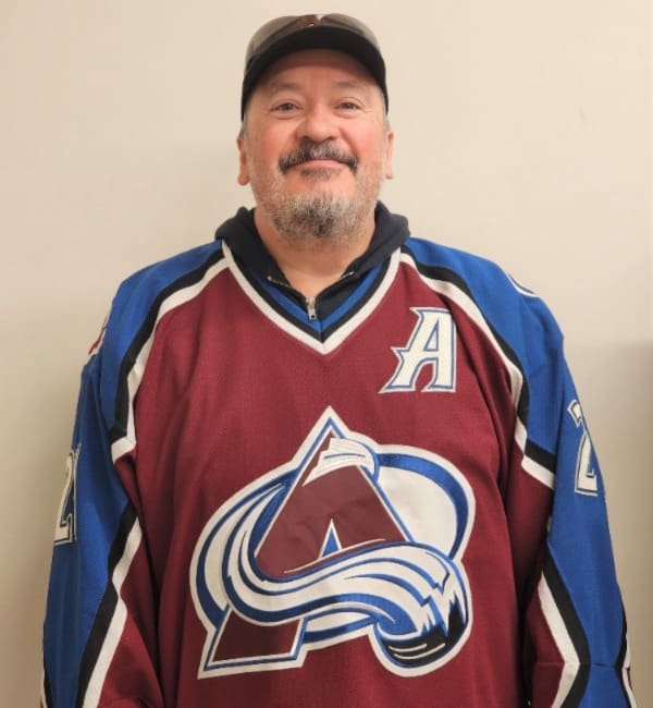 A man in a hockey jersey and hat.