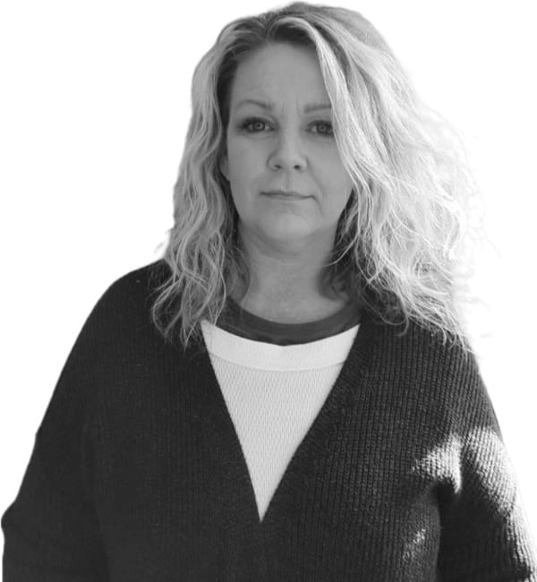 A black and white photo of a woman in a sweater.