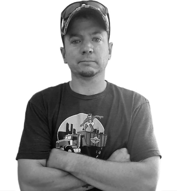 A man in a baseball cap and t-shirt with his arms crossed.