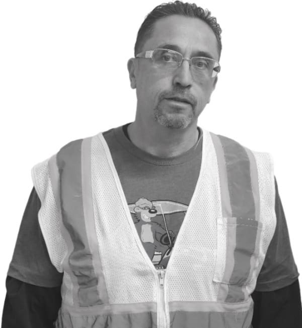 A man wearing safety vest and glasses.