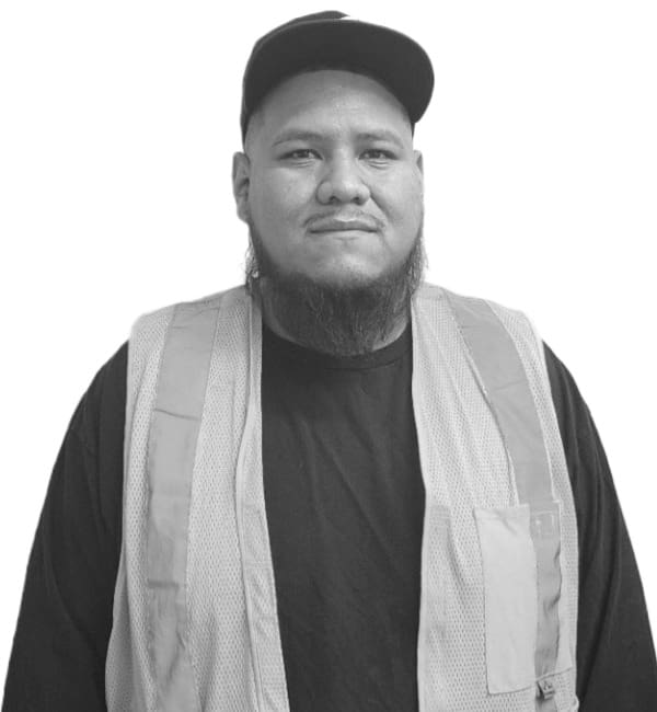 A man with a beard wearing a hat and vest.