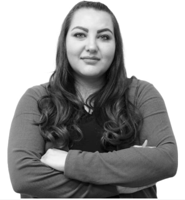 A woman with her arms crossed in front of the camera.