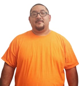 A man in an orange shirt is standing up