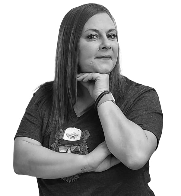 A woman with her arms crossed and wearing glasses.