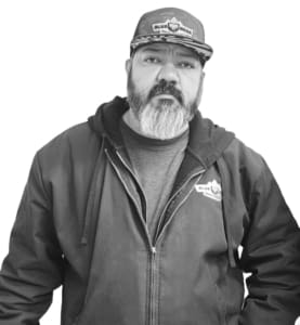 A man with a beard and mustache wearing a jacket