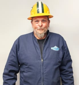 A man in a yellow hard hat and blue jacket.