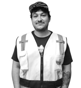 A man wearing an industrial vest and hat.