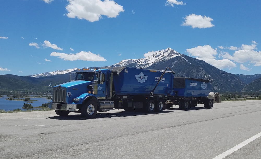 Denver mountains and dumpster rental truck